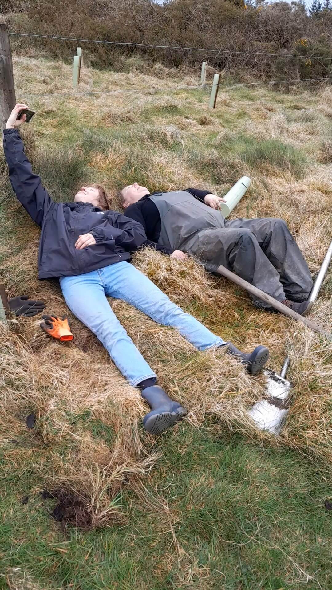 2 hard working volunteers having lie down in some hay